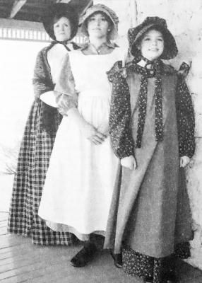 February 2009: Back to front, Suzan Mayfield, Samantha Vela, and Anna Sams show their late 19th century finery at the Annie Riggs Memorial Museum. The three are hoping to participate in the planned Period Promenade April 4, one of the events marking the 150th anniversary of the founding of Historic Fort Stockton.