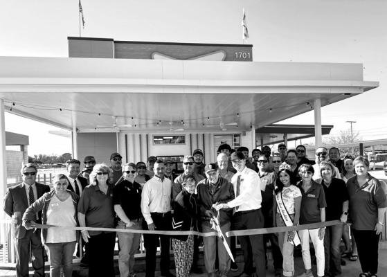 Members of the community gathered to celebrate Sonic’s grand re-opening and present a new official membership plaque to owners Travis and Tommie Lewis.