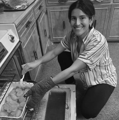 CUTLINE: Dinner Tonight Cooking Club member Alexis Ramirez pulls a dish out of the oven at a recent gathering. Courtesy photo