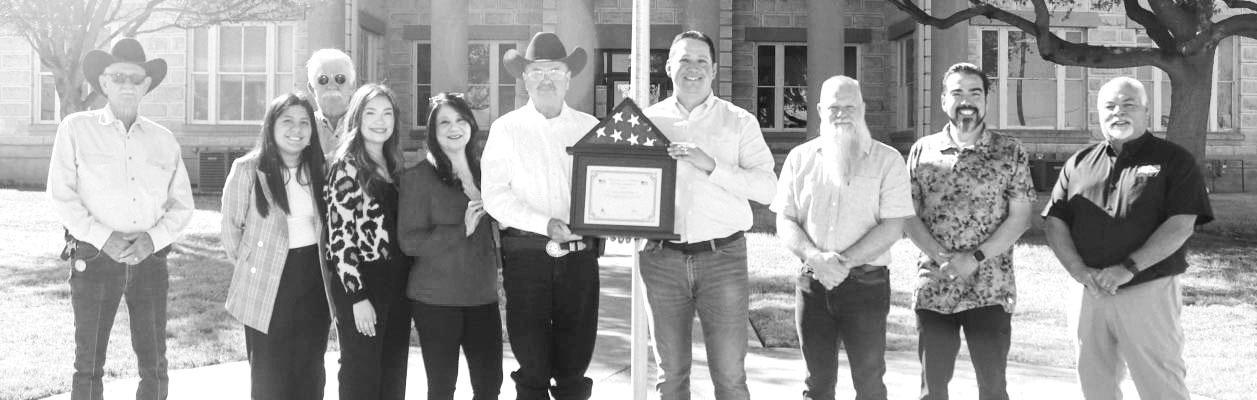 Officials gathered in front of the Pecos County Courthouse Feb. 21 as Congressman Tony Gonzales presented Pecos County Sheriff T.J. Perkins with a flag in honor of his 35 years of law enforcement service.
