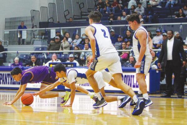 Fort Stockton sophomore Aryan Hernandez, middle, goes after a loose ball during the Panthers win over Pecos on Feb. 8. Photo by Nathan Heuer