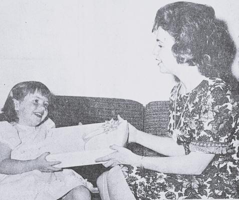 MAY 1968- HAPPY MOTHER’S DAY- Karla Chadwell, age 3, presents her mother, Mrs. Bill Chadwell, with Mother’s Day