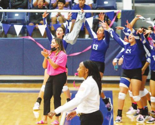 Fort Stockton first-year head volleyball coach Gabrielle Harral (pink) changed the trajectory of the Prowlers volleyball program in just one season this year, leading her program to nine more wins than a season ago. Harral is pictured with a smile during her team’s win against Andrews on Oct. 5. Photo by Nathan Heuer