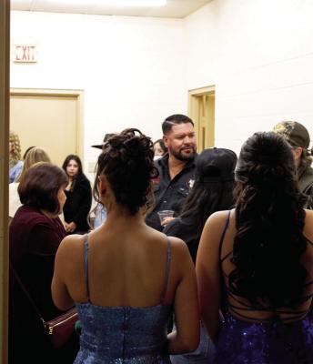 The people who brought the Glitz event to life took a moment before the show began to prepare. Photo by Joh Covington
