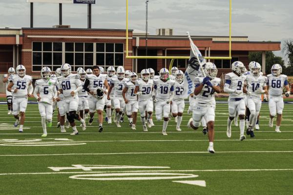 Taking Charge - The Varsity Panthers run out on the field for their first game of the season. Courtesy Photo