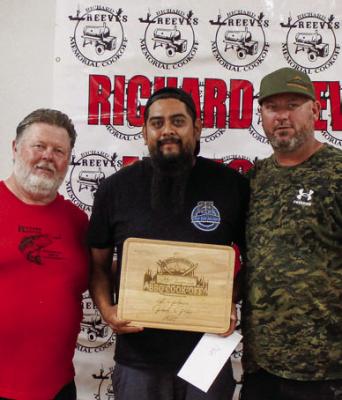 Erik Torres, middle, from team UPPERCUT Smokers won the Ribs Division.