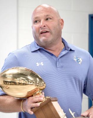 Fort Stockton Athletic Director and Head Football Coach DJ Howell holds one of the Panthers’ Gold Ball trophies from seasons past during the Decals with Dads event earlier this year. Howell has emphasized that honoring the program’s history is part of building an “elite” future—reminding his players that every new standard begins with the legacy they choose to carry forward. Photo by Tristian Barragan, Fort Stockton Pioneer
