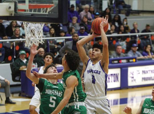 Fort Stockton’s Aryan Hernandez attacks the basket through a double team of Monahans’ Robert Brooks, middle, and Drayton Montez (5) during the teams matchup on Feb. 3 at the Special Events Center. Photo by Nathan Heuer