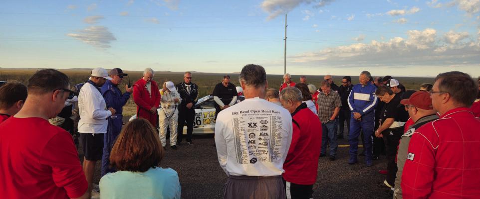 The BBORR racers take a moment after their team meeting to bow their heads for everyone’s safe return and in thanks for the opportunity to do what they love. Photo by Joh Covington