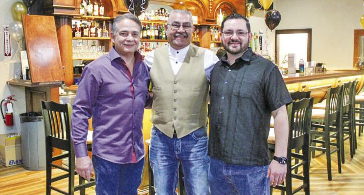 Centennial Bar &amp; Lounge Owner Albert Valadez, left, is pictured with his son Adrian Valadez, right, who is a minority owner of the business, and Roy Ramos, who was the main contractor that renovated the building, on New Year’s Eve. Ramos is a Fort Stockton native that is the president of Unique Refinishing &amp; Woods, Inc. out of Odessa. Photo by Nathan Heuer