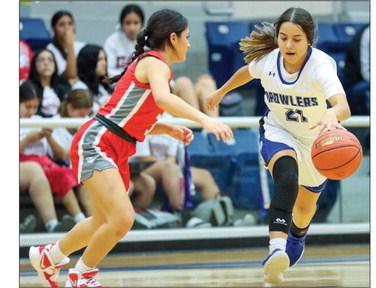 Fort Stockton senior point guard Yvette Lopez dribbles around a Denver City defender earlier this season. File photos by Shawn Yorks