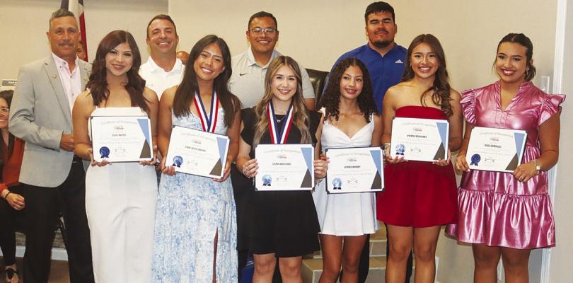 Fort Stockton Mayor Paul Casias, left, honored the Fort Stockton High School Powerlifting team and coaches at the March 25 council meeting. The girls placed sixth overall at the state meet, Belle Urbano placed fifth individually, and Jasmin Hernandez was the state champion in the 97-pound weight class. Photo by Shawn Yorks