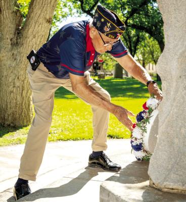 COMMEMORATIVE WREATHS — New commemorative wreaths, donated by Gerardo and Darla Pules, are displayed during the ceremony led by County Veteran Service Officer Michael Pules. Photo by Tristian Barragan