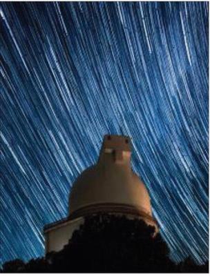 Star trails zoom past the dome of the Harlan J. Smith Telescope. Photo Credit to Ethan Tweedie Photography
