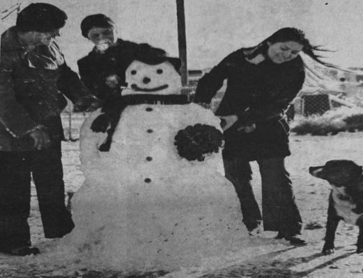 JANUARY 1973- FUNNY FACE AND FRIENDS- Howie the dog gives his approval to the handywork of the Vasquez sisters, left to right, Rena, Suyen and Elaine, who built a large snowman after which they aptly named Funny Face. The girls, daughters of Mr. and Mrs. Joe Vasquez of 1108 N. Missouri, gave the snowman a woolen scarf and a floppy hat to keep him warm, and a wiener nose which looks mighty good to Howie. (Pioneer Photo)