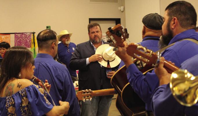 Last Friday, the Pecos County Historical Commission hosted the Texas Treasure Business Awards at the FMH Meeting Hall. The evening was made complete with a performance by Mariachis Los Parientes de Pedro Moreno, pictured here playing a favorite song of Dan Frank’s, President of First National Bank of Fort Stockton. The Bank received one of the business awards that evening. Photo by Joh Covington