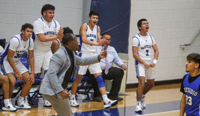 The Fort Stockton bench, including Cruz Rojas (second from left), Aryan Hernandez (middle), Luis Medina right, celebrate a teammates basket that capped their team’s second quarter run during Tuesday’s home game against Presidio. Photo by Nathan Heuer