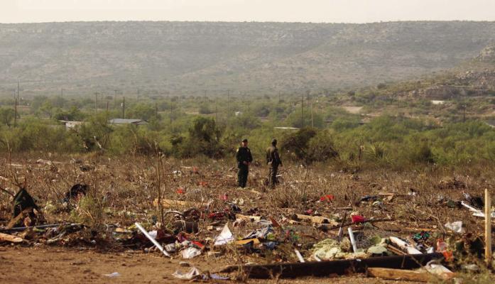 Two Border Patrol agents overlook the destruction in Sanderson, left in the wake of a tornado that tore through the small town on Sunday evening. Photo by Keirstin Pratt