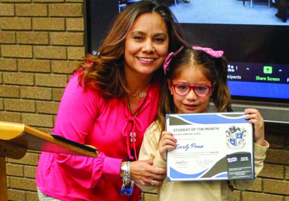 Apache Student of the Month Everly Pena, right, and principal Karina Pacheco.