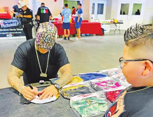 Saturday’s “The Arrival” wrestling event drew an impressive crowd of 250 attendees to the Fort Stockton Convention Center. The wrestler known as Akantus is pictured signing “luchador”wrestling masks at his merchandise table. Photo courtesy of Brenda DelaO, City Marketing and Sales Coordinator.