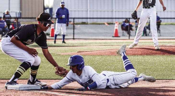 Fort Stockton junior Marco Garcia slides safely back to first base while Andrews’ Daylon Jefcoats, left, is a tad late on a tag from a pickoff attempt. Photo by Shawn Yorks