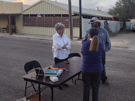 Alice Duerksen and crew hands out ribbons for the arch to memorialize loved ones. Photo by Kerry Waldrip