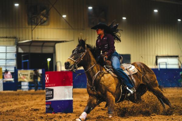 Precision and Speed - A barrel racer rounds a turn during the timed events at the Pecos County Coliseum. As the award-winning rodeo enters its sixth year, it continues to attract high-caliber contestants from across the country.