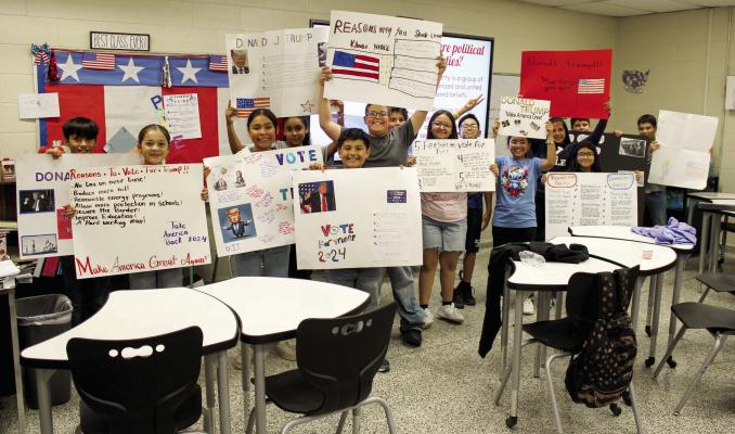 For this year’s General Election, the Fort Stockton Intermediate School developed a simulated election experience for the students. Pictured here is one of the classes with the political signs they designed themselves. On Tuesday, their library was opened up for them to vote for their candidate as well as decisions regarding the school. Photo by Joh Covington