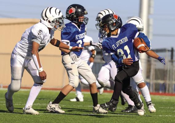 A Fort Stockton runner avoids and Alpine Cowboys defender and races for a touchdown in the Flag Division of the 17th Annual Fort Stockton Recreation Department Pop Warner Football Invitational at Panther Stadium, Dec. 3. Fort Stockton won over Alpine, 34-26, but Alpine was driving downfield and just ran out of time.