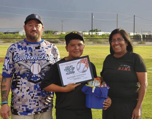 Lucy and Adam Marler present Mathew Natividad with the “YOLO” Award in a ceremony at the Shuster West Field. Photo by Tristian Barragan