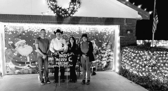 The Keep Historic Fort Stockton Beautiful board recognition for the most merry and bright. Pictured from left to right are Board member Lawson Kemp, T. J. Perkins, Maribel Perkins, Board member Dulcia Warren. Photo Courtesy of Keep Historic Fort Stockton Beautiful