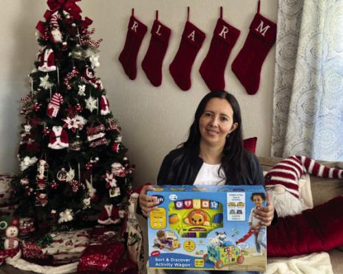 Catalina Riley, chair of community service, poses with a new toy for the Rotary Toy Drive.