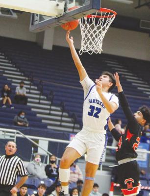 Fort Stockton’s Christian Mireles (32) finishes a layup during the first half of Tuesday’s game against McCamey at the Special Events Center. (Photo by Nathan Heuer)