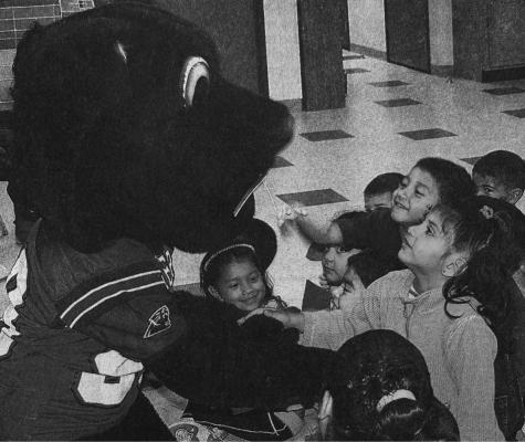 October – 2004 – One Big Panther – Headstart students Jaedon Castro and Sarahi Subia get to know the Panther mascot during a pep rally held last Thursday at the school. The Fort Stockton High School varsity cheerleaders led the students in cheers and school songs.