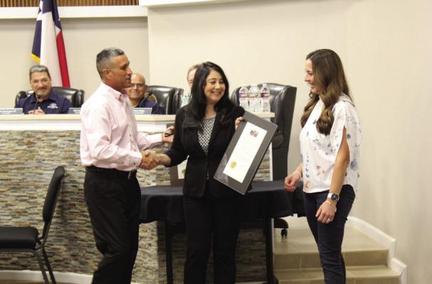 Mayor Paul Casias presents valuable members of the municipal court with a dedication in honor of their service to the community. Photo by Joh Covington.