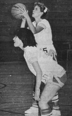 December - 1980 — Eyeing The Basket - Lessa Young eyes the basket as she prepares to shoot a free throw. Teammate Melba Reyes bites her lips as she waits to battle for a possible rebound.