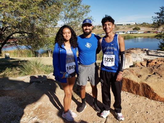 Ali Jackson, left, and Fabian Perez, right, pose with the Fort Stockton head cross country coach Sergio Guardiola after the duo qualified for the Class 4A state cross country meeting on Oct. 25 in Lubbock. Courtesy Photo