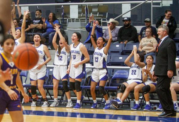 The Prowler bench celebrated their victory following Arial Smith’s 3-pointer in the final seconds of Tuesday’s district home game against Pecos. Pictured from left to right is Amaya Urias, Sophia Hernandez, Victoria Maldanado (12), Mia Garcia, Thiara Wislar, Jocelynn Arcides (22), Priscilla Trevino, and head coach Lea Daggett. Photo by Nathan Heuer