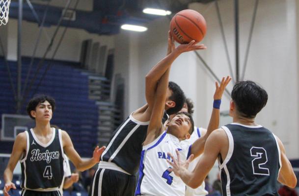 Freshman Diego Ronquillo scraps for an offensive rebound against a Horizon defender during the teams matchup on Dec. 16 at the Special Events Center. Horizon won the game 66-51. Photo by Nathan Heuer