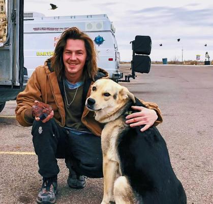 Holding a glossy piece of mahogany obsidian in one hand, Logan wrapped his other arm around his chummy pooch Newman. The duo has been out on the road collecting a variety of rocks throughout the nation. Photo by Jeremy Gonzalez