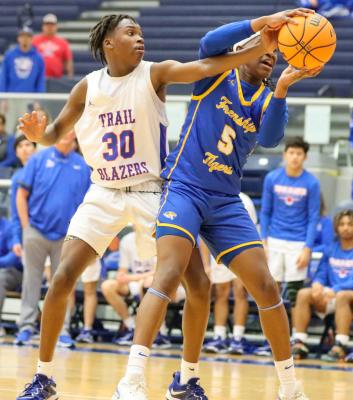 Wolfforth Frenship freshman Chase Campbell, right, grabs a rebound over El Paso Americas junior Lareon Johnson during the Class 6A Bi-District playoffs, Tuesday in Fort Stockton. Frenship won the game, 73-46 to improve to 29-4 on the season. The Tigers advance to the area round this weekend against Fort Worth Chisholm Trail. Photo by Shawn Yorks