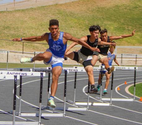Fort Stockton junior Zane Hodges, left, clears a hurdle on the curve of the 300 hurdles race at the area track meet in Andrews on April 21. Hodges placed second in the event at the area meet and fourth in the event at the regional meet. Photo by Nathan Heuer
