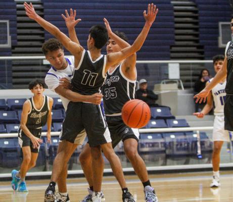 Fort Stockton senior Isaiah Garcia, left, passes out of a double team during the Panthers home tournament – West Texas Shootout – at the Special Events Center on Dec. 16 against Horizon. Photo by Nathan Heuer