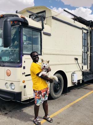 Garrett, a digital nomad, holds onto his Pomsky (Pomeranian-Husky) Joey. The duo stepped out of a school bus converted into an RV, which is another impressive combination on its own. Photo by Jeremy Gonzalez