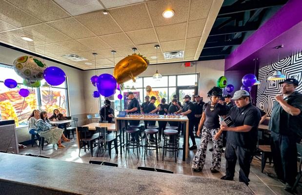 Employees celebrate before grand opening inside with cupcakes.