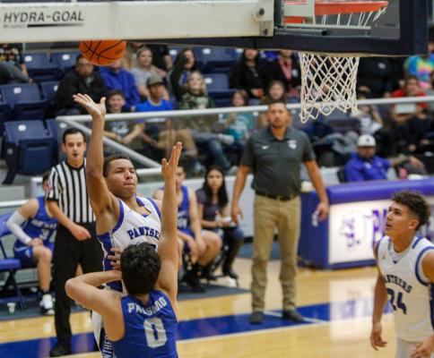 Fort Stockton junior Isaiah Garcia, left, elevates for a layup during the West Texas Shootout against Presidio at the Special Events Center on Dec. 9. Photo by Nathan Heuer