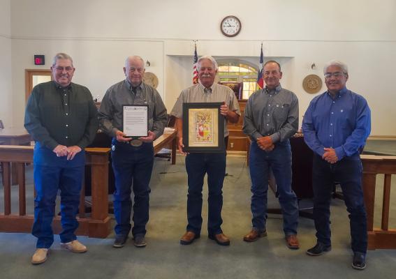 (From left to right):  commissioner Tom Chapman, rancher Warren Nutt, judge Joe Shuster, and commissioners Mickey Jack Perry and Santiago Cantu. Photo by Megan Wehring