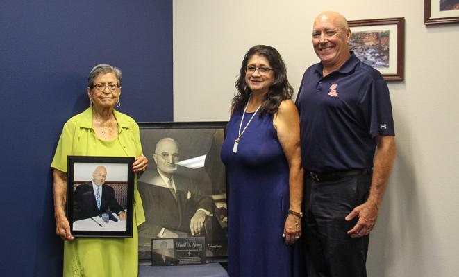 Isabel Gomez is holds a photo of David “Tex” Gomez while David’s sister Irma Patton holds the donated picture of former President Harry Truman. The items were donated to FSHS on July 16. Also pictured is Jeffrey Patton (right). Photo by Megan Wehring.