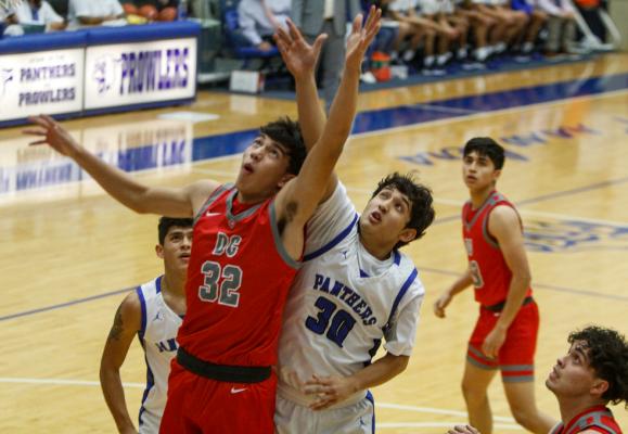 Fort Stockton’s Elias Sanchez (30) battles for a rebound with Denver City’s Daniel Ceniceros (32) on Dec. 14. The contest was the last home game to date for the Panthers. Photo by Nathan Heuer