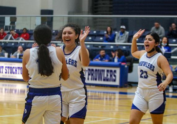 Fort Stockton’s Sophie Hernandez, middle, and Nayeli Ramos, right, embrace their teammate Mia Garcia, left, and she made a layup while getting fouled during the Prowlers win over Sweetwater. Photo by Nathan Heuer